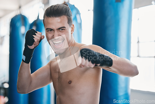 Image of Sports, boxing and man in gym for training, workout and exercise for martial arts or mma fight. Fitness, body builder and face of excited male athlete ready for boxer competition, practice and punch