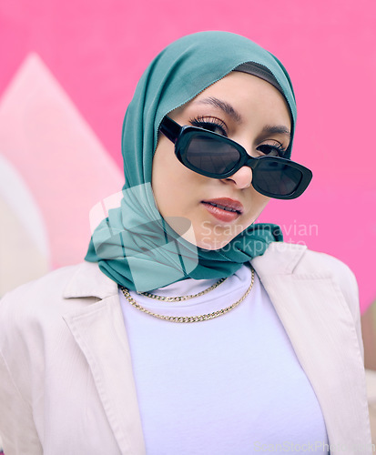 Image of Young muslim woman, fashion and portrait by wall with trendy gen z aesthetic, beauty and art deco in city. Edgy islamic girl, student and clothes with sunglasses, freedom and travel in Dubai metro