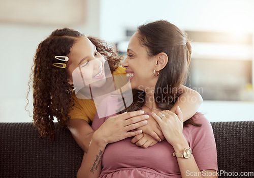 Image of Love, hug and mother with girl on a sofa, relax and happy in their home together, sweet and caring. Family, embrace and child with parent in living room, smile and hugging while having fun on weekend