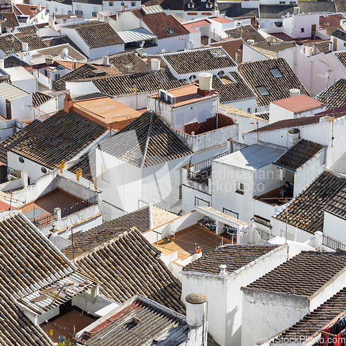 Image of Aerial panoramic view of rooftops of white houses of Olvera town, considered the gate of white towns route in the province of Cadiz, Spain