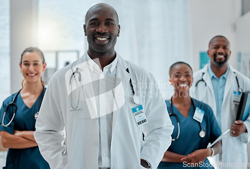 Image of Happy, doctor and portrait of black man with team for medical help, insurance and trust in clinic. Healthcare, hospital and professional male and women health worker for service, consulting and care