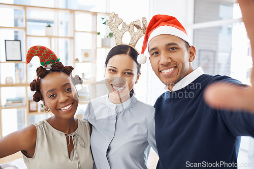 Image of Selfie, christmas party and friends in an office together at a function for celebration as a business team. Portrait, smile and festive with a happy group of employees posing for a photograph at work