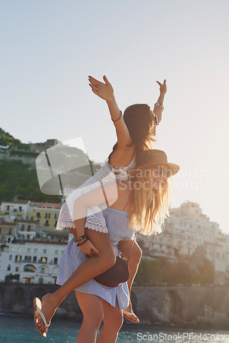 Image of Vacation piggyback, free and women in summer for freedom, city adventure and walking in Spain. Smile, travel and young friends being carefree together on a holiday in a small town by the ocean