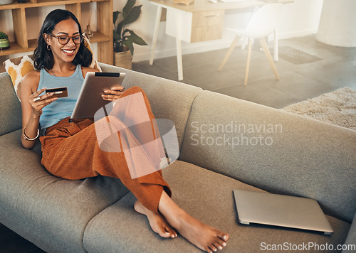 Image of Ecommerce, credit card and woman on a sofa, tablet and transactions with online shopping, home and relax. Female person, happy client or customer on a sofa, technology or buying with internet banking