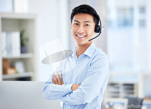 Image of Call center, portrait and man with arms crossed for telemarketing, customer service and support. Face, contact us and confident sales agent, happy Asian consultant and crm professional from Japan.