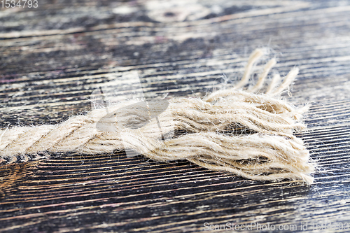 Image of broken and untangled thick linen rope