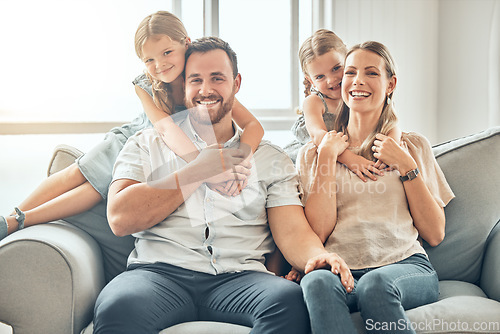 Image of Portrait of mom, dad and children on sofa in living room for bonding, quality time and relax together. Happy family, smile and parents hugging girls for care, love and support at home on weekend