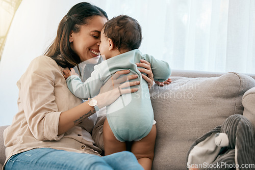 Image of Love, happy and mother with baby on a sofa for playing, games and laughing in their home together. Family, smile and mom with girl toddler on a couch, relax and bonding, fun and hug in a living room