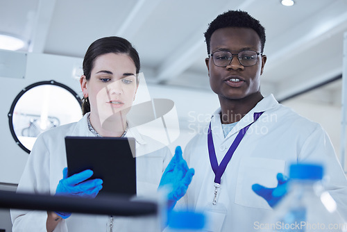 Image of Science, black man or woman with a tablet, research or scientific experiment in a laboratory, medical or healthcare innovation. Coworkers, typing and female employee with male scientist or technology
