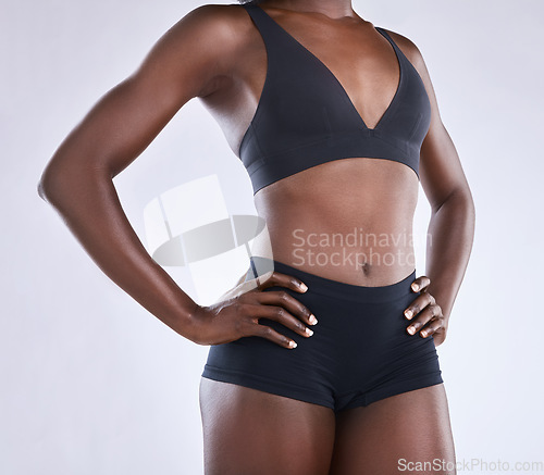 Image of Body, stomach and health with black woman in studio for nutrition, weight loss and diet. Fitness, wellness and abdomen muscle with closeup of female model on white background for self care and glow