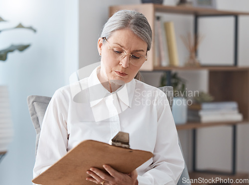 Image of Woman, therapist and writing on clipboard in consultation for mental health, psychology or healthcare. Female person or psychologist taking notes in therapy session on form or report for counseling