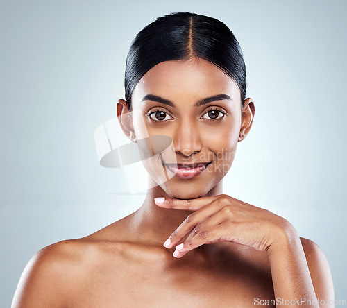 Image of Smile, beauty and portrait of a woman with skincare cosmetic isolated in a studio white background. Clean, Cosmetics and natural female person or model hand on her face happy for self love or care