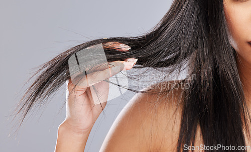 Image of Hair in hands, damage and woman in studio with worry for split ends, haircare crisis and weak strand. Beauty, hairdresser and closeup of upset female person with frizz problem on gray background
