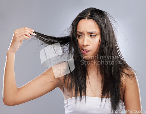 Image of Hair care, damage and woman with worry in studio for split ends, haircare crisis and weak strand. Beauty mockup, hairdresser and face of upset female person with frizz problem on gray background