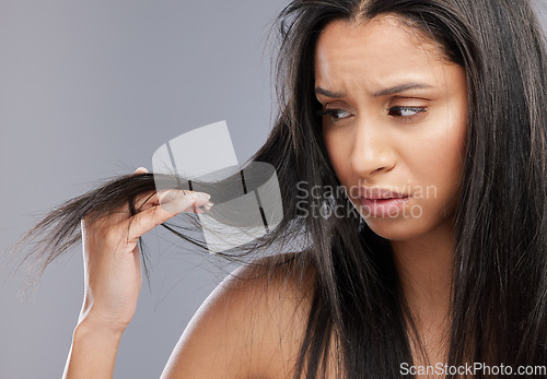 Image of Hair, damage and face of woman worried in studio for split ends, haircare crisis and weak strand. Beauty, hairdresser and upset female person with frizz, dry and loss problem on gray background