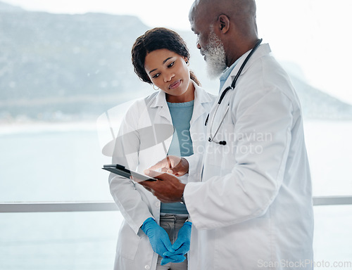 Image of African doctors, teamwork and talking with tablet, data analysis or results for healthcare in hospital. Senior black man, woman and medical discussion with digital touchscreen for wellness in clinic