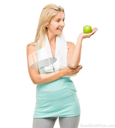 Image of Apple, fitness and towel with a senior woman in studio isolated on a white background for health. Exercise, nutrition and diet with a happy mature female athlete holding fresh fruit for weightloss