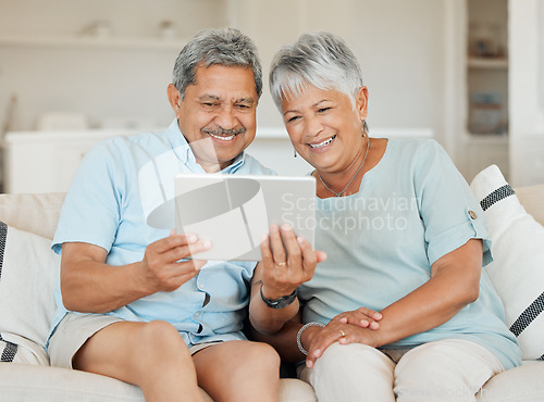 Image of Technology, married couple with tablet and smile on couch in living room of their home. Connectivity, social networking and happy with elderly people on couch streaming a movie on sofa in house