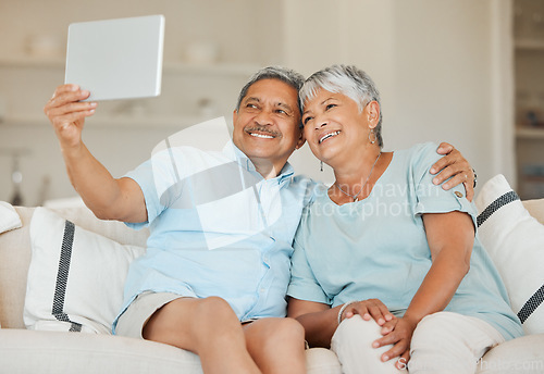 Image of Technology, selfie and married couple with tablet on a sofa in living room of their home. Happiness, social networking and love with elderly people on an online video call with internet connection