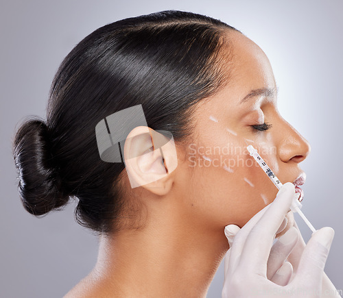 Image of Face, filler and injection with woman in studio for plastic surgery, dermatology and beauty. Pattern, aesthetic and medical with model and syringe on grey background for collagen and cosmetics