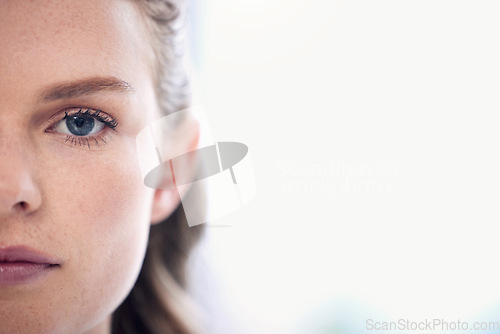 Image of Woman, focus and half face with a healthy vision for awareness in australia for closeup. Serious, portrait and female person with eyes for concentration with eye test for wellness and seeing.