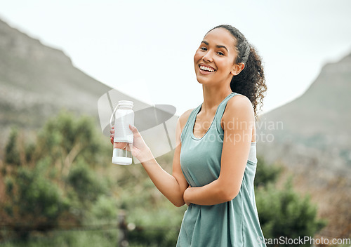 Image of Woman with water bottle, smile in portrait outdoor with fitness, hydration and health with mockup space. Happy female person workout in nature, h2o drink and wellness with healthy active body