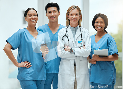 Image of Portrait, leadership and a doctor woman arms crossed, standing with her team in a hospital for healthcare. Insurance, medical and teamwork with a female health professional in a clinic for treatment