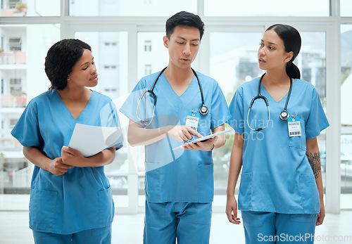 Image of Teamwork, discussion or surgeons with tablet planning strategy in hospital in collaboration meeting. Leadership, doctors or nurses talking or speaking of healthcare research, reports or digital news