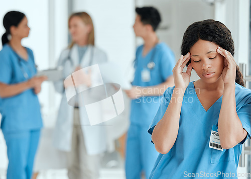 Image of Headache, anxiety or sad nurse in meeting with doctors with burnout, stress or fatigue with medical emergency. Migraine, tired black woman or depressed surgeon with depression or loss in hospital