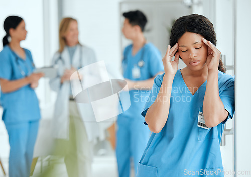 Image of Headache, anxiety or sad surgeon in meeting with doctors with burnout, stress or fatigue with medical emergency. Migraine, tired black woman or depressed nurse with depression or loss in hospital