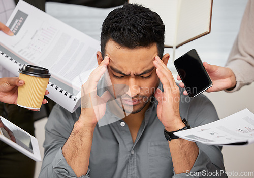 Image of Business man, headache and overwhelmed burnout from work chaos and company in a office. Anxiety, frustrated and male employee feeling overworked from report deadline, paperwork and project problem