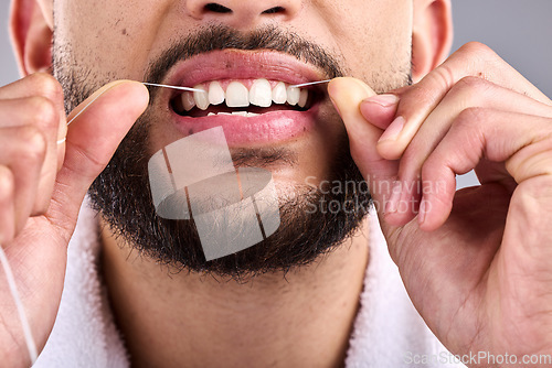 Image of Mouth, man and flossing teeth for dental health in studio isolated on a white background. Closeup, floss and male model cleaning tooth for oral wellness, hygiene and healthy product for fresh breath.