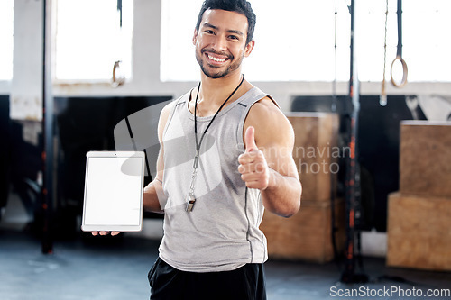 Image of Portrait, thumbs up and man with tablet screen in gym for mockup after exercise. Face, like hand gesture and personal trainer with technology, happy and space for marketing, advertising and fitness.