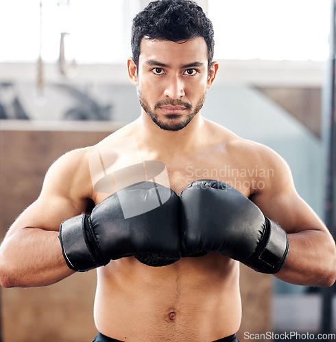 Image of Portrait, boxer and serious man in gym for exercise, battle and training for fight. Face, boxing and male athlete, fighter or sports person workout, fitness and practice for martial arts challenge.