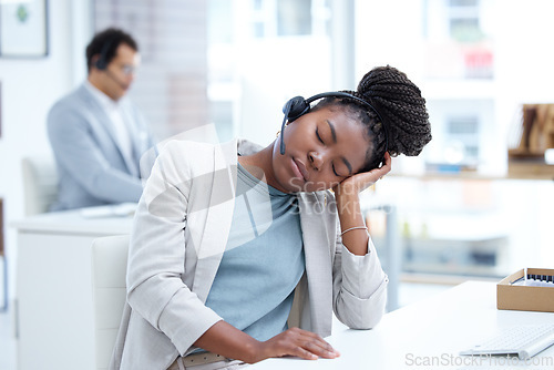 Image of Call center, tired and woman sleeping with headset for telemarketing, sales or customer service. Black female consultant or agent at crm, tech support or help desk with stress, burnout or fatigue