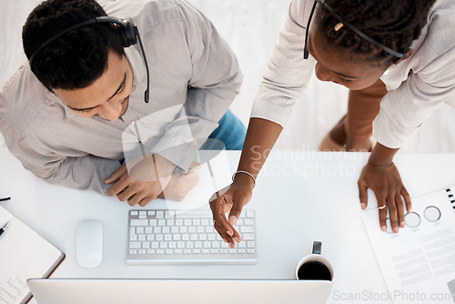 Image of Call center, top view and training with business people and computer for coaching, customer service or communication. Help desk, contact us and mentor with man and black woman for teamwork from above