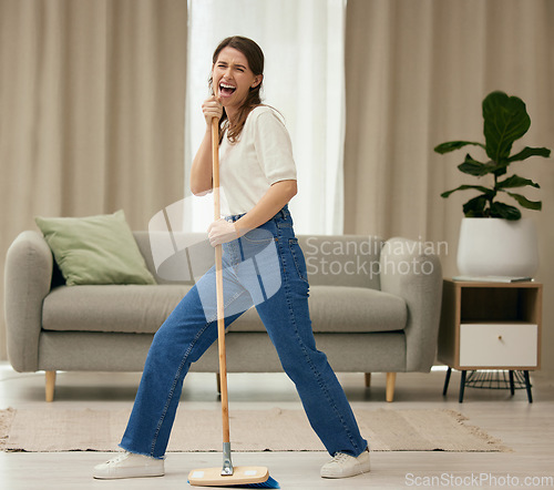 Image of Woman, singing and broom to clean living room with funny dance, sweeping floor or performance in home. Girl, comic singer and cleaner with spring cleaning, music or working to stop dust, dirt and job