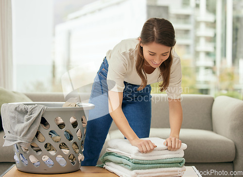 Image of Cleaning, laundry and towels with woman in living room for housekeeping, fabric and chores. Cotton, maintenance and linen with female cleaner at home for washing, hospitality and housekeeper services