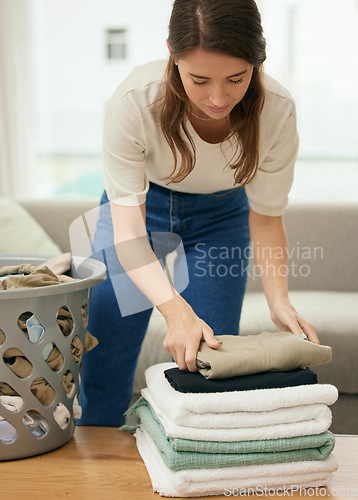 Image of Cleaning, laundry and housekeeping with woman in living room for towels, fabric and chores. Cotton, maintenance and linen with female cleaner at home for washing, hospitality and housekeeper services