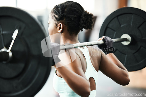 Image of Black woman, back with weightlifting and fitness, barbell in gym and strong bodybuilder with muscle training. Sport, workout and bodybuilding, female athlete in exercise studio, challenge and power