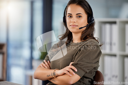 Image of Young woman, call center portrait and arms crossed for telemarketing in headphones, voip mic and communication. Girl, customer service and technical support consulting for contact us in modern office
