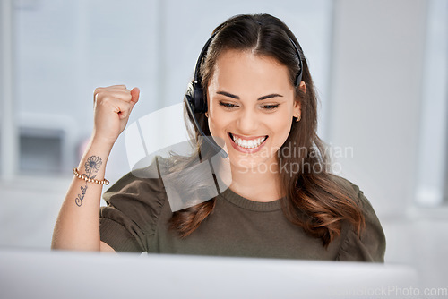 Image of Happy, success or excited consultant in call center on target for winning a telemarketing or telecom bonus. Computer, winner or happy virtual assistant with a smile for victory or goals achievements