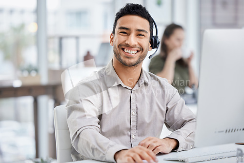 Image of Customer service, portrait of male call center agent with headset and with computer at his desk of a modern office workplace. Telemarking or support, communication and male person at his workstation