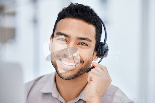Image of Man, call center and portrait of working at office desk, computer or job in telemarketing, communication or sales. Indian agent, happy employee or work in consulting, customer service or crm business