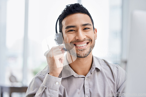 Image of Indian man, call center and portrait of working at office desk, computer or job in telemarketing, communication or sales. Agent, happy employee or work in consulting, customer service or crm business