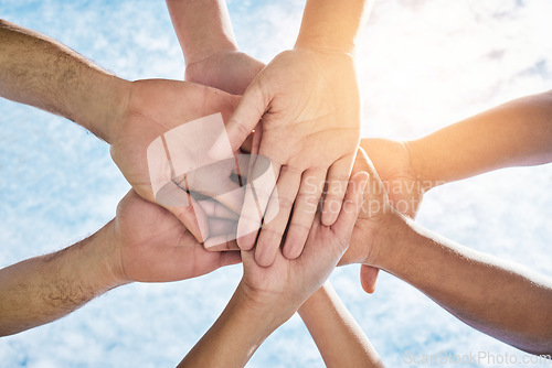 Image of Hands in circle together, blue sky and community in collaboration for world support, trust and diversity. Teamwork, hand and summer sunshine, positive mindset and group of people in solidarity huddle