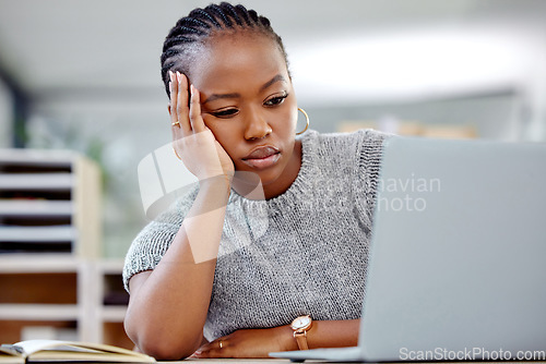 Image of Mental health, businesswoman with a headache and laptop at her desk in a modern office workplace. Depression or sad, anxiety or tired and female person with a problem or mistake at her workstation