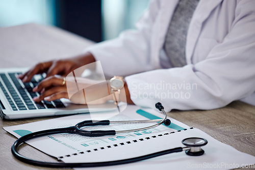 Image of Closeup, hands and doctor with a laptop, stethoscope and typing with connection, documents and telehealth. Black woman, female person or employee with a folder, medical equipment and digital planning