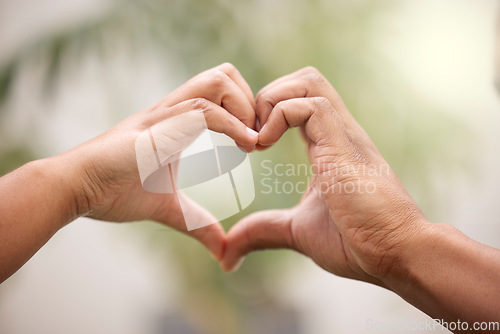 Image of Heart, hands sign and couple outdoor for care, affection or bonding together. Love, hand gesture and man and woman support, trust or empathy, kindness and emoji for commitment, marriage and loyalty.