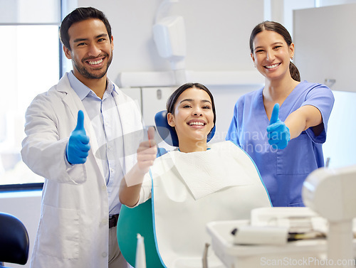 Image of Dentist team, patient and thumbs up portrait for.consultation, clean or teeth whitening. Woman, asian man or healthcare staff and client together for dental care, oral health exam and mouth cleaning